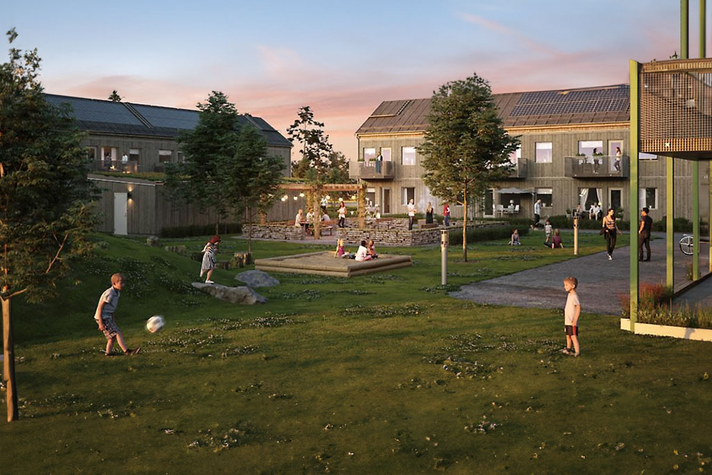Illustration över hur området skulle kunna se ut. I illustrationen syns en gemensam grönyta mellan ett antal bostäder. Bostäderna är i trä och på grönytan syns barn leka. Det finns även en gemensam uteplats där det sitter folk. 